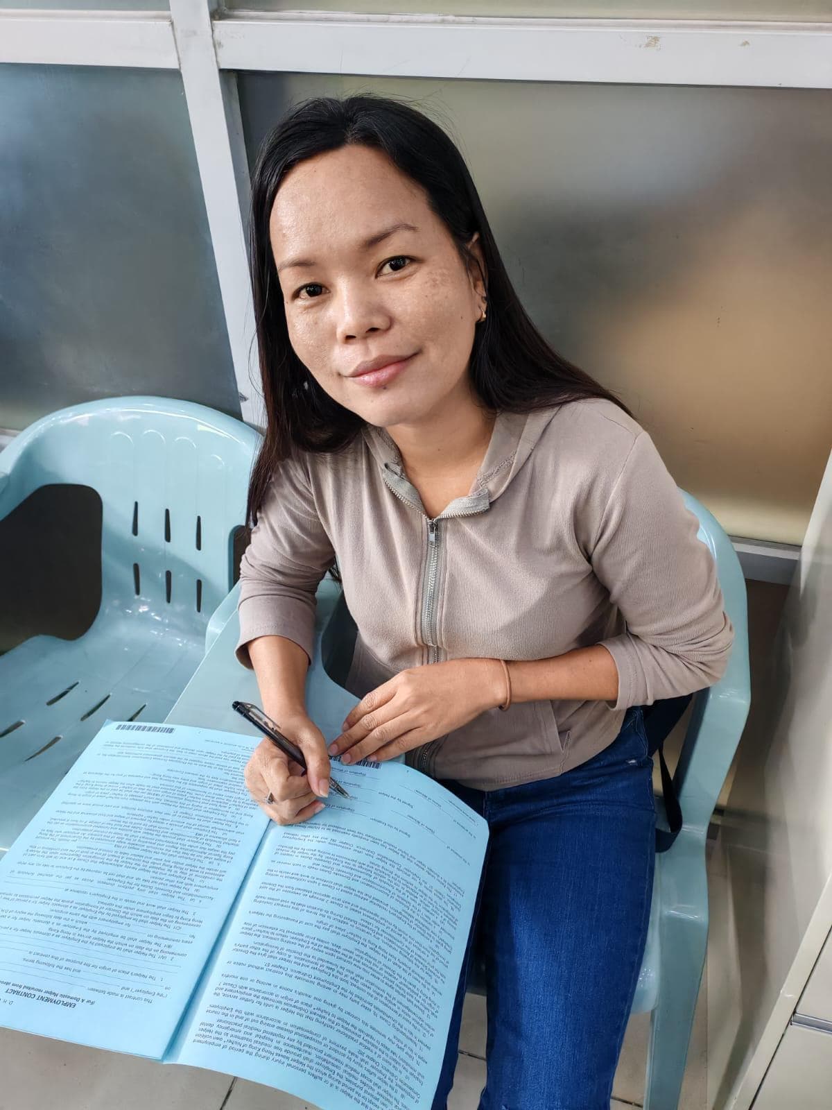 Helper signing employment documents